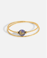 Liliflo_Schmuck, modular, swiss made_Doppelt gedrehtes Milonga-Armband_Farbe Gelbgold mit einem nachtblauen Murano Aube mit Blattgold